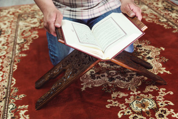 Muslim man reading Islamic holy book quran