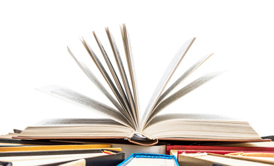Opened book on the hardback books. Isolated on white.