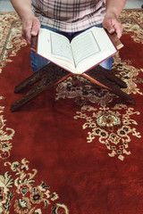 Muslim man reading Islamic holy book quran