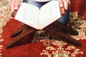 Muslim man reading Islamic holy book quran