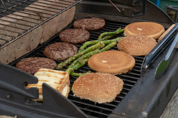 Hamburger Set. The person is going to grill beef patties, sausages, grilled cheese and asparagus