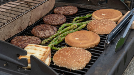 Hamburger Set. The person is going to grill beef patties, sausages, grilled cheese and asparagus
