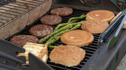 Hamburger Set. The person is going to grill beef patties, sausages, grilled cheese and asparagus