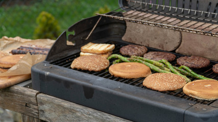 Hamburger Set. The person is going to grill beef patties, sausages, grilled cheese and asparagus