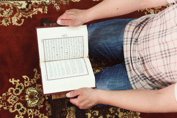 Muslim man reading Islamic holy book quran