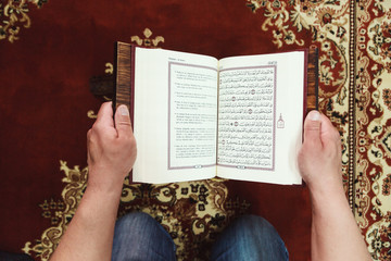 Muslim man reading Islamic holy book quran