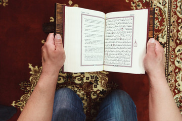 Muslim man reading Islamic holy book quran