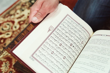 Muslim man reading Islamic holy book quran