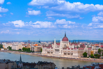 Fototapeta na wymiar Panoramic cityscape view of hungarian of the Parliament - is currently the largest building in Hungary. Beautiful gothic and renaissance architecture style. Summertime sunny day in Budapest, Hungary.