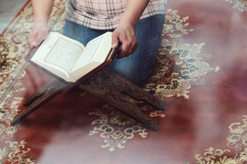 Muslim man reading Islamic holy book quran