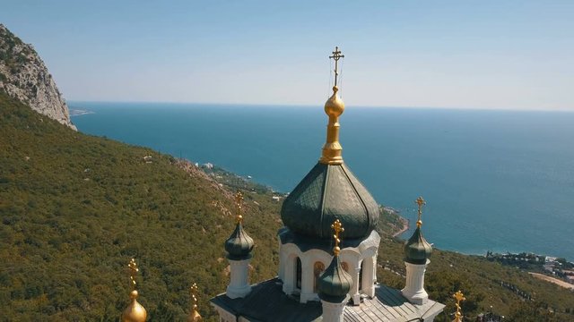 Orthodox church on a steep cliff. Sea and mountains on a background. Aerial view of Foros Church on a mountain over the sea.