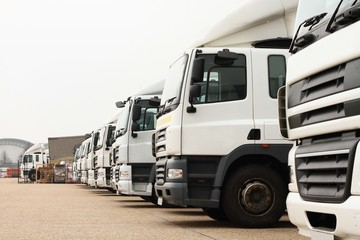 lorries parked up outside a company's car parking area ready to deliver goods to customers stock photo