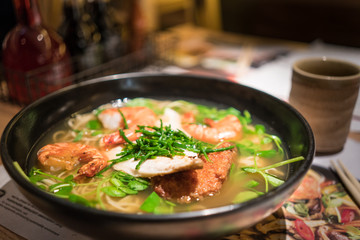 A large bowl of Japanese Ramen with meat, prawn and vegetable
