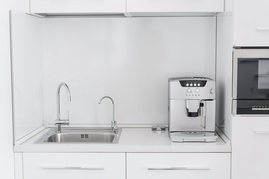 Metal Chrome Sink With Two Taps, Plain And Filtered Water. Fragment Of Modern Kitchen With Counter And Sink. Detail Of Interior Apartment.