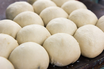 Fototapeta na wymiar Kneaded lumps of dough ready to be spread out and fried into a flatbread called 