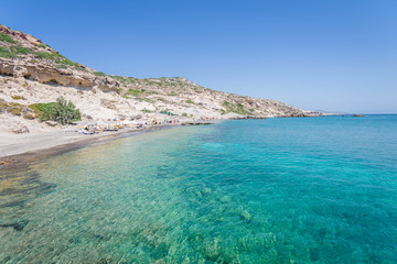 Beautiful sunny coast view to the greek mediterranean blue sea with crystal clear water and pure sandy beach empty place with some mountains rocks surrounded, Kefalos, Kos Island, Dodecanese, Greece