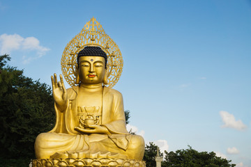 Obraz premium Large golden Buddha statue at Sanbanggulsa temple, Sanbang-ro, Jeju Island, South Korea