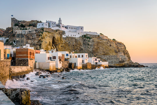Beautiful sunset sunrise coast view to old ancient monastery church on a cliff of mediterranean greek village Mandraki, Monastery of Panagia Spiliani, Nisyros Island, Kos, Dodecanese, Greece 
