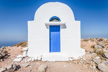 Holy greek white blue chruch chapel of agios Ilias shining above a greek island over the mediterranean sea on the edge of the volcano stefanos on the island of Nisyros, Kos, Dodecanese, Greece