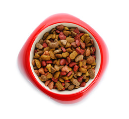 Red bowl with cat food on white background, top view. Pet care
