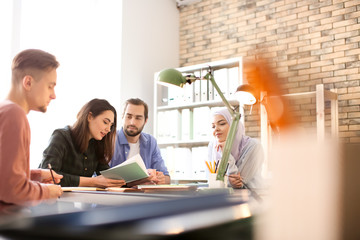Muslim student with classmates in library