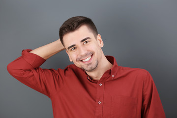 Charming young man on grey background