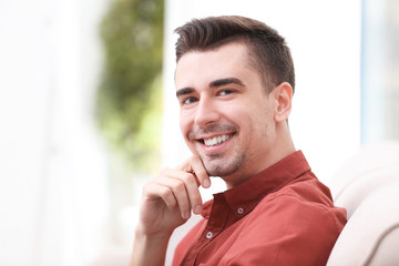 Young man in casual clothes indoors