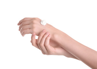 Young woman applying hand cream against on white background