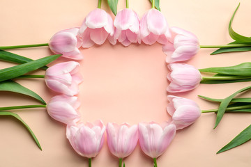 Fototapeta premium Beautiful frame made of tulips for Mother's Day on color background