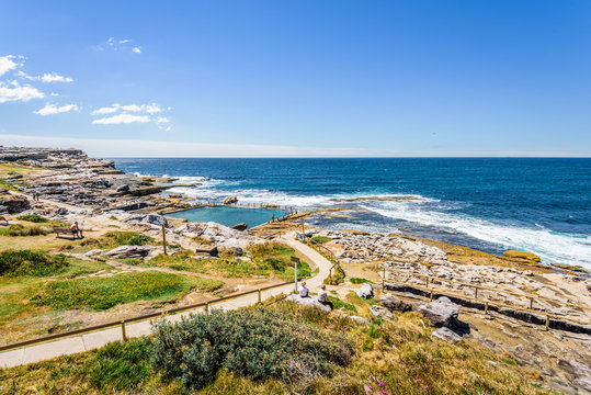 Sunny beautiful summer coast view to the blue Tasman Sea with wild wave water and rocky sharpe cliffs at shore perfect for fishing and hiking, swiming dangerous, Sydney, NSW, Maroubra Beach, Australia