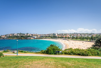 Obraz premium Sunny beautiful summer coast view to Sydney beach and blue Tasman Sea wild wave water and sandy white beaches perfect for surfing swimming hiking, Coogee to Bondi Walk, NSW/ Australia - 10 11 2017