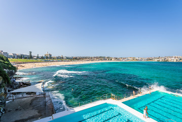 Sunny beautiful summer coast view to the famous sandy Bondi Beach and blue Tasman Sea with great waves perfect for surfing or swimming in pools, relax, Bondi Beach, Sydney, NSW/ Australia - 10 12 2017