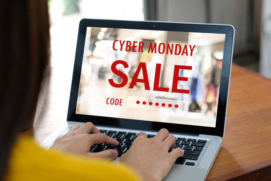 Hand typing discount coupon code on laptop screen to get the shopping on line cyber monday promotion, on line shopping ,digital marketing business and technology, lifestyle concept