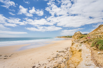 Sunny beautiful summer coast view to the blue sea and pure white sand beach dune limestone sandstone rocks perfect for surfing swimming and hiking, Star of Greece, Port Willunga, Adelaide, Australia