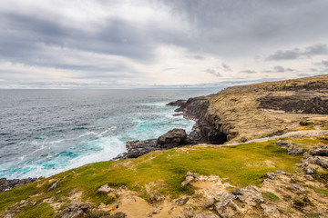 Relaxing at the blue Bass Strait sea and enjoying a warm sunny beach view over blue sky water of Great Ocean Road with a few clouds horizon over small town Port Fairy, Melbourne, Victoria, Australia