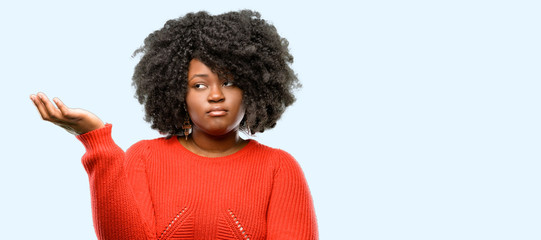 Beautiful african woman irritated and angry expressing negative emotion, annoyed with someone, blue background