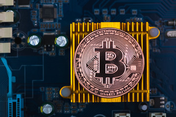 Bitcoin digital currency,  bit-coin on motherboard or electronic board with chips, Cryptocurrency money concept