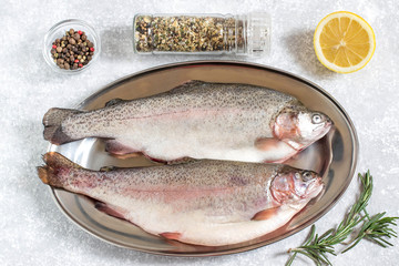 Two fresh trout and ingredients for cooking