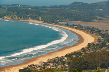 View of beach and houses form the cliff side