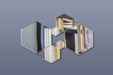 Abstract interior with geometric mirrors on an isolated background. Hexagonal mirrors, fashionable composition in the interior