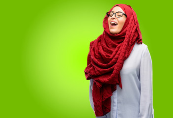 Young arab woman wearing hijab confident and happy with a big natural smile laughing