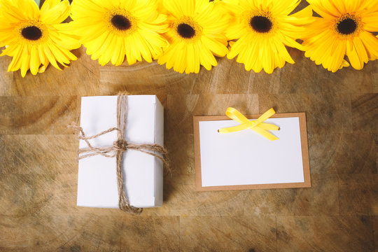 Little gift box with with yellow flowers in a rustic style