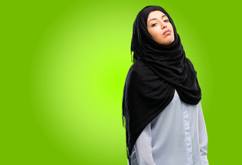 Young arab woman wearing hijab with sleepy expression, being overworked and tired