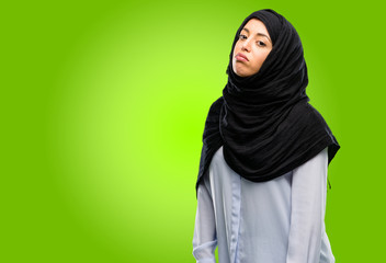 Young arab woman wearing hijab with sleepy expression, being overworked and tired