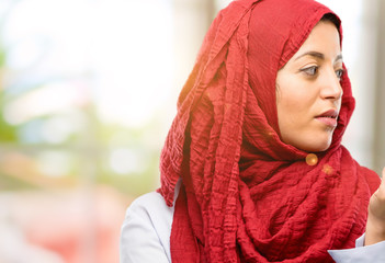 Young arab woman wearing hijab with crossed arms confident and serious