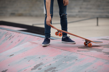 Fototapeta na wymiar Skateboarder sakteboarding on skatepark ramp