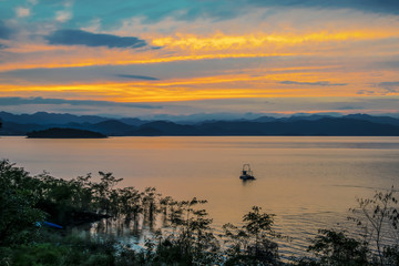 Fototapeta premium Sunset at lake, Kaeng Krachan Dam, Chaipattana Water Turbine.