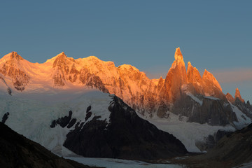 Alpenglow warm morning light touch the Cerro Torre, the mountains in the Southern Patagonian Ice...