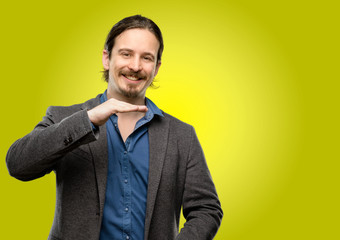 Handsome young man holding something, size concept