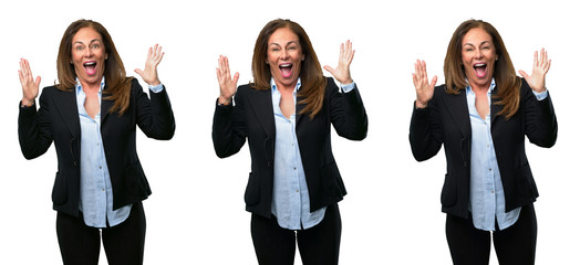 Middle age business woman happy and surprised cheering expressing wow gesture over white background